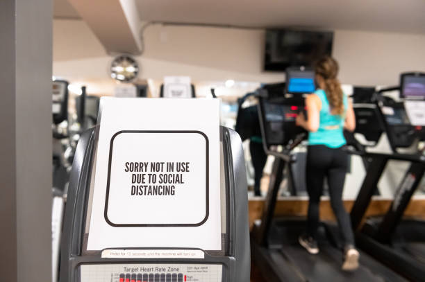 Exercise room with a sign on one of the machines that says "Sorry not in use due to social distancing"