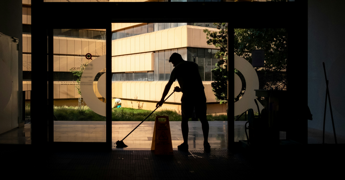 Person mopping entrance of a building