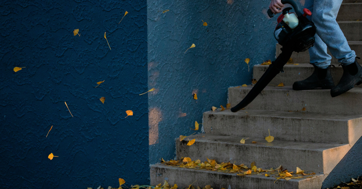 person using leaf blower on outside stairs